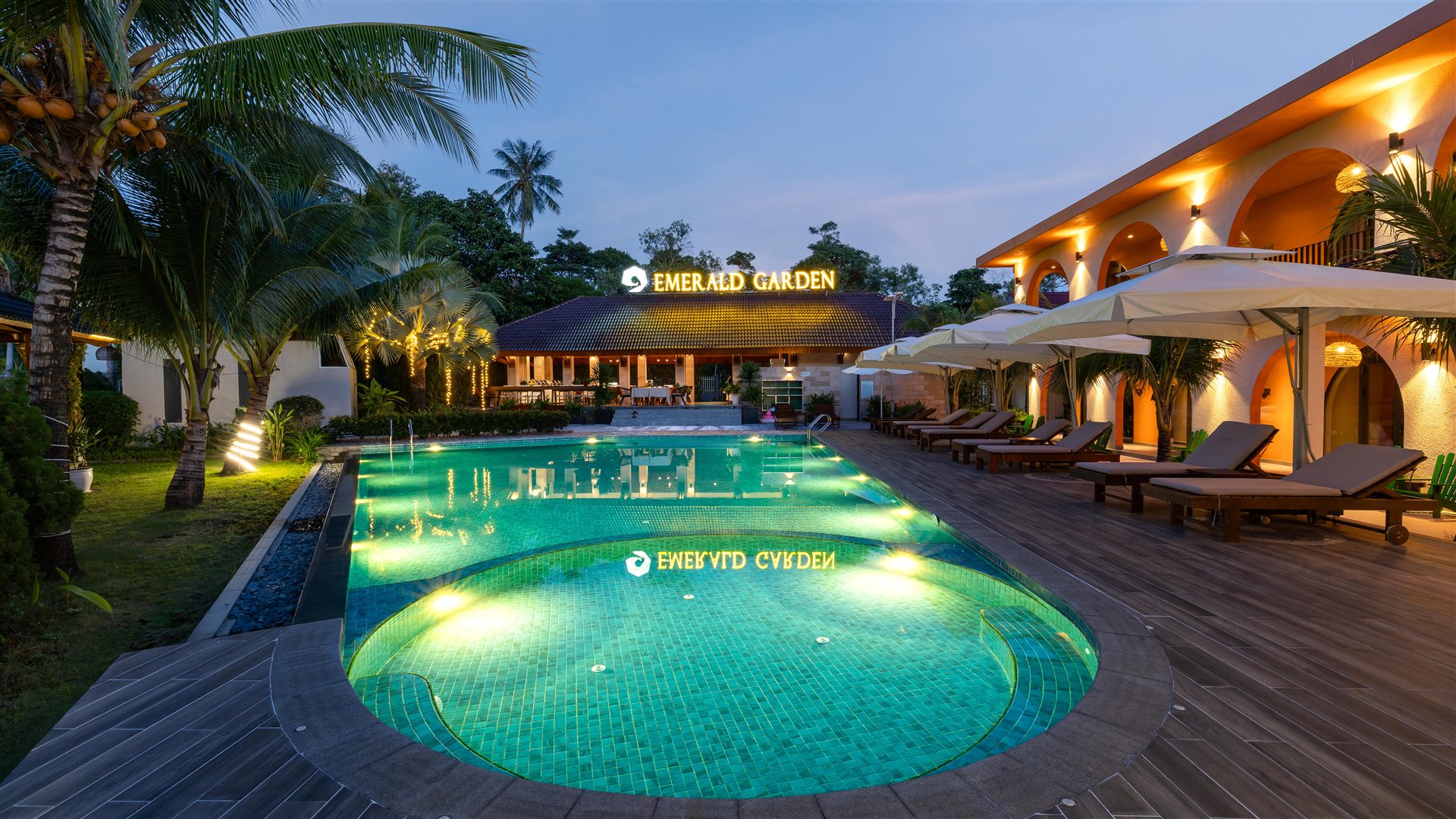 The emerald pool and glowing garden rooms at dusk